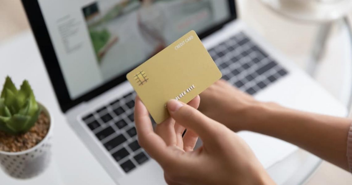 Close,Up,Woman,Holding,Golden,Plastic,Credit,Card,Mockup,With